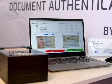 Workstation for document verification with scanner and laptop, which displays the results of a digital identity check.