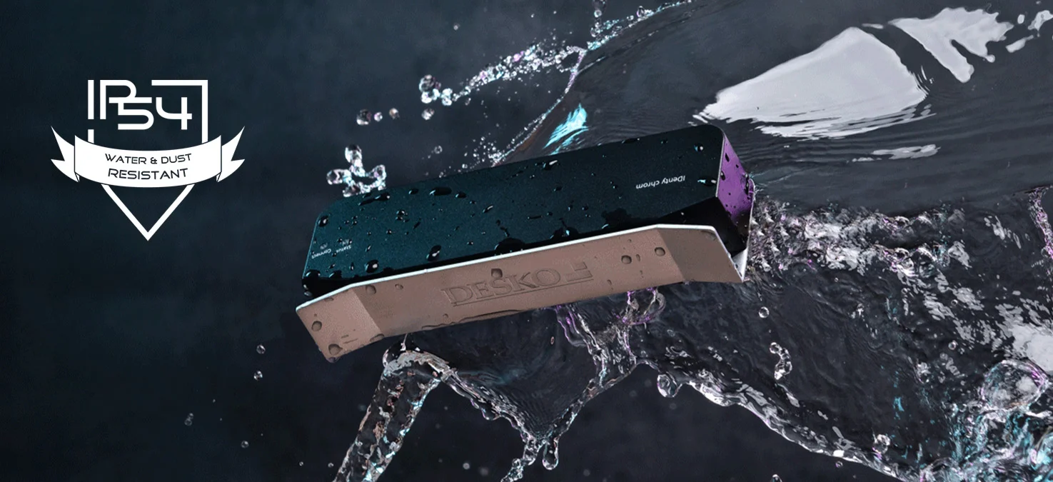Robust DESKO scanner lies in splashing water, drops on the housing, with IP54 symbol for water and dust protection.