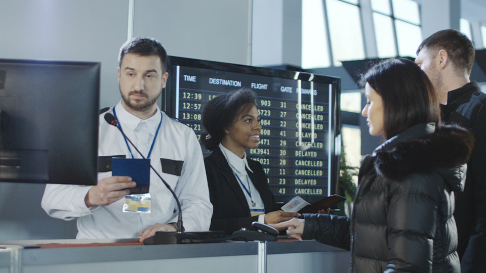 Airport passport control: a man checks a passport