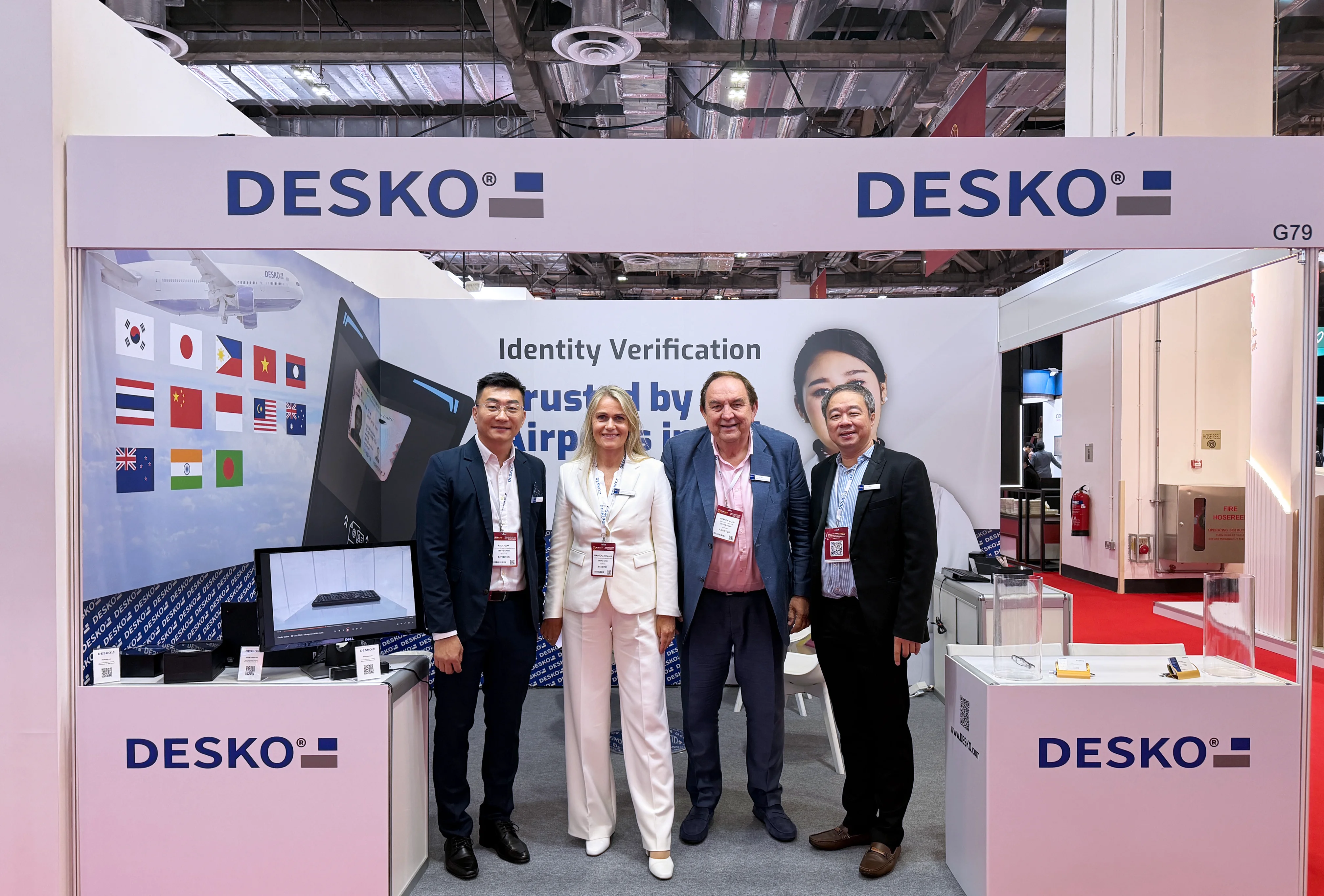 The DESKO trade fair team are standing side by side at their stand at PTE Asia 2026.
