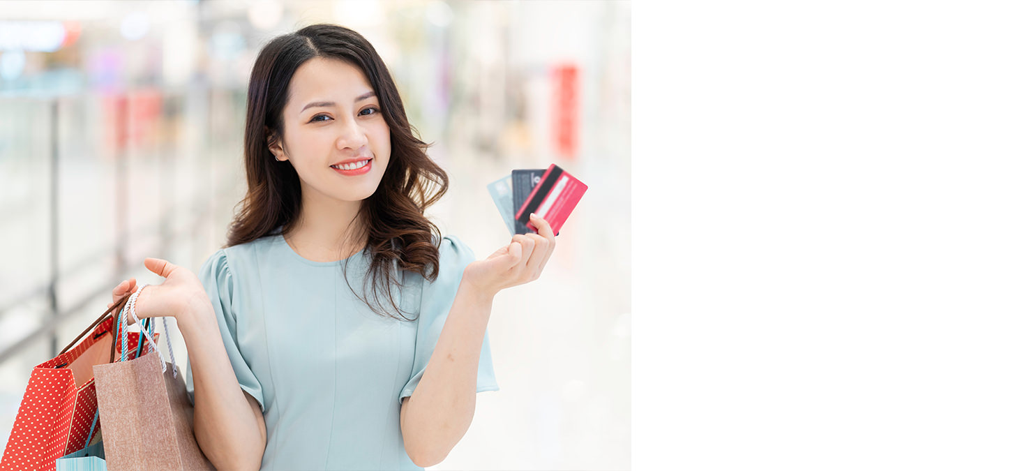 Woman with hand luggage in airport shopping mall.