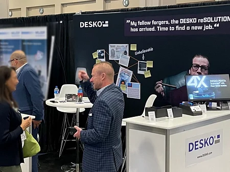 DESKO trade fair stand with reSOLUTION branding, product demo of the 4X scanner and discussions with visitors at a trade fair.
