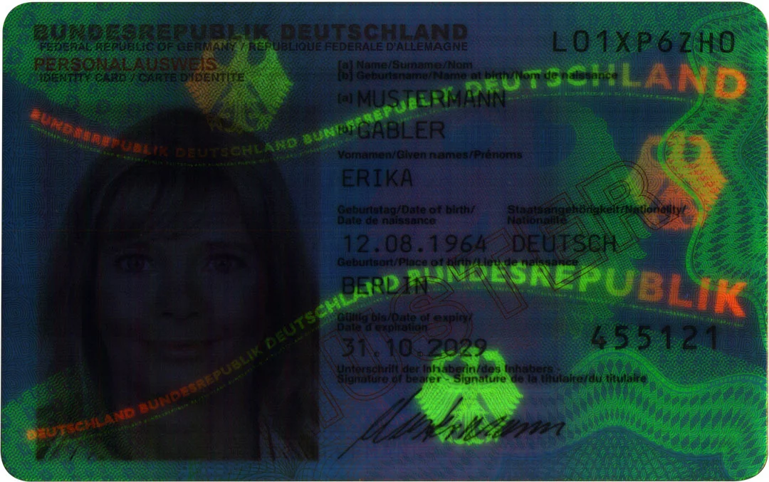 UV image of a German ID card with fluorescent security patterns, lettering and concealed portrait.